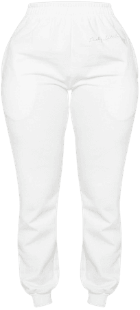 white joggers w/ blue embroidery