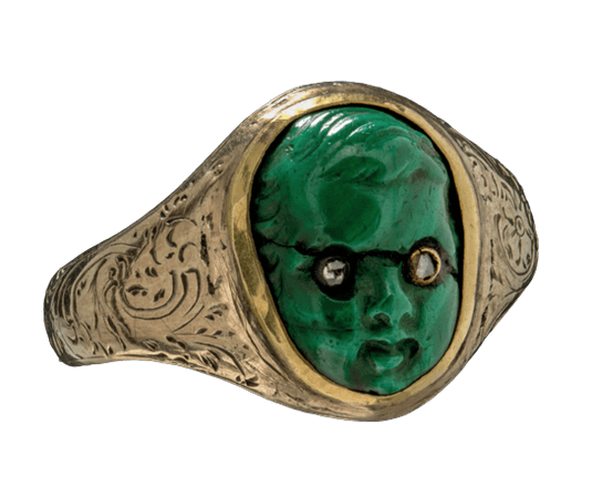 c. 1870 gold ring featuring the carved green stone face of a cherub with inset diamond chip eyes