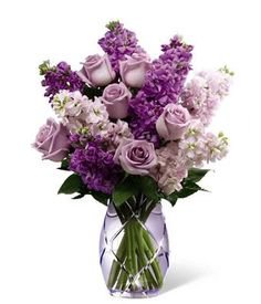 purple flower bouquet in glass vase