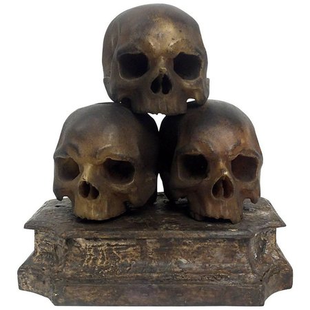 A rare Italian Wunderkammer Memento Mori sculpture depicting three skulls made out of colored wax and leaning on a marble painted wooden base, Italy, circa 1820.