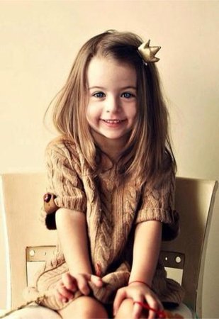 Cute toddler girl with brown hair and blue eyes