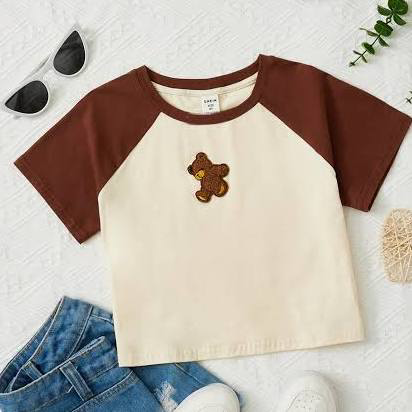 brown shirt with small teddy bear on it