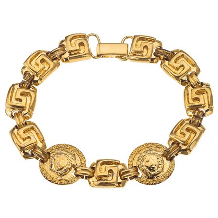 Gianni Versace gold toned bracelet with Medusa and Greca $760