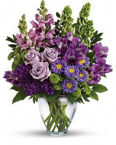 purple flower bouquet in glass vase
