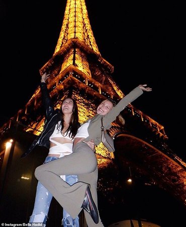 Bella Hadid playful poses in front of the Eiffel Tower with a pal during Paris Fashion Week | Daily Mail Online