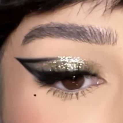 frosty glam makeup look with silver glitter and black graphic eyeliner