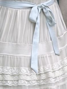 white and blue dress with blue ribbon