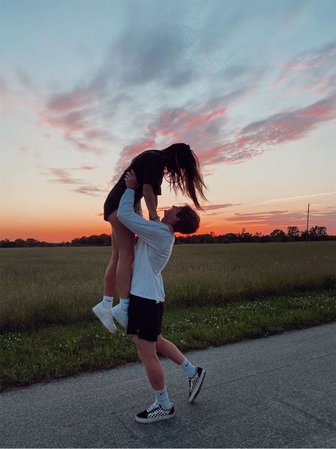 boyfriend holding girlfriend - sunset