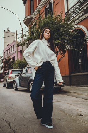 woman in white sweater stands in middle of street photo – Free Barranco Image on Unsplash
