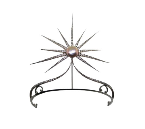 Circa 1890, a starburst diamond tiara with a natural buttonshaped pearl at center.