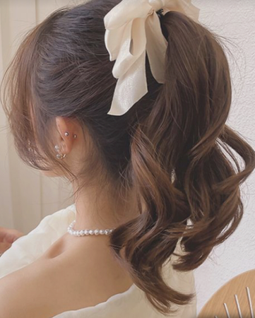 brown hair in high ponytail in white ribbon