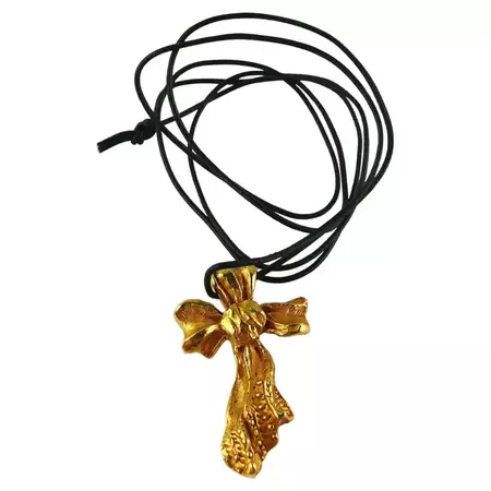 Christian Lacroix Vintage Gold Toned Ribbon Cross Pendant at 1stDibs | ribbon cross necklace, pat 1094483, christian lacroix cross necklace