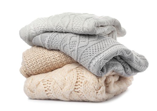 Stack of folded knitted sweaters