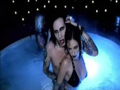 Marilyn Manson in a pool with a babe