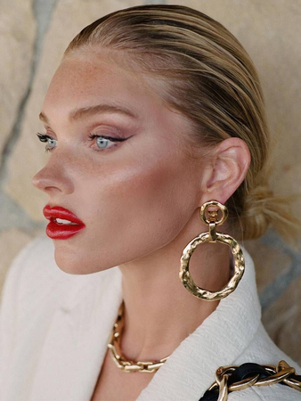 Model face makeup red lips earrings ellenium