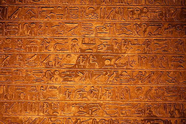 egyptian-hieroglyphics-on-a-beige-stone-picture-id157637350 (612×408)