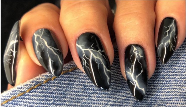 Black with white lightning bolt nails