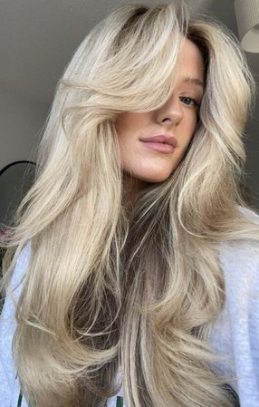 long fluffy blonde hair with curtain bangs