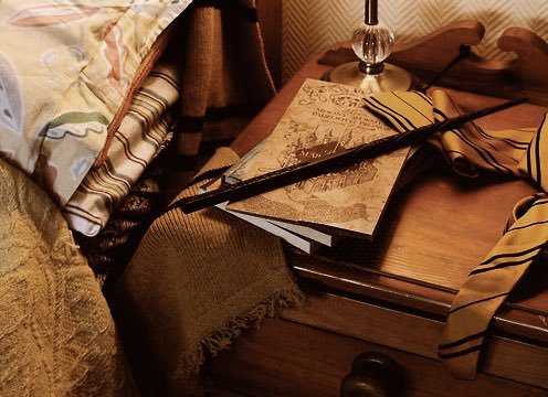 Harry Potter and the marauder's map on a Hufflepuff's nightstand
