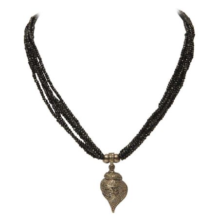 Black Spinel with Diamond Conch Shell Pendant with Buddhist Om For Sale at 1stDibs