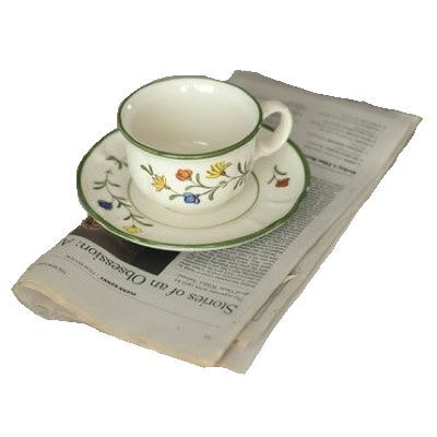 Newspaper with teacup