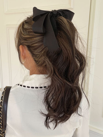 high ponytail with black bow ribbon
