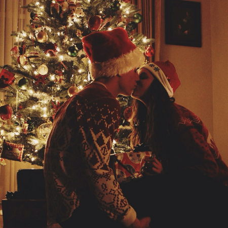 kissing by the christmas tree