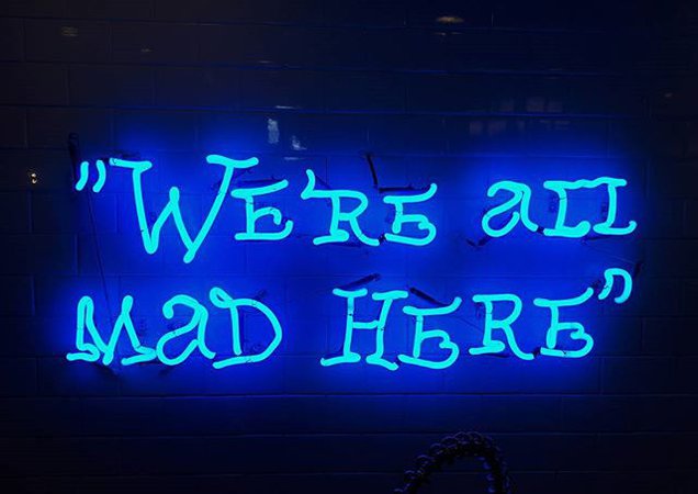 'We're All Mad Here' neon sign