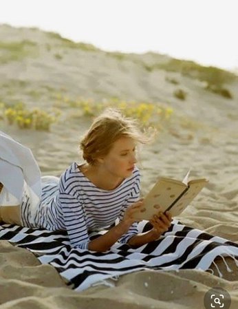 girl on beach reading Pinterest