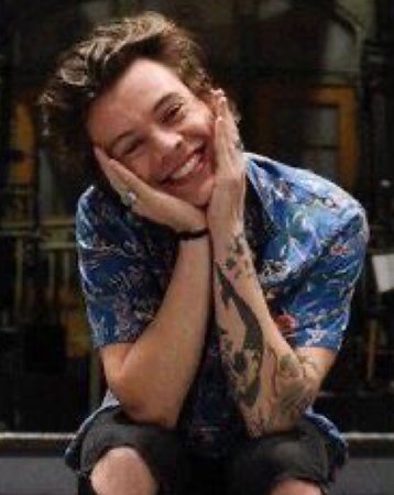 Harry Styles poses mood lighting smiling