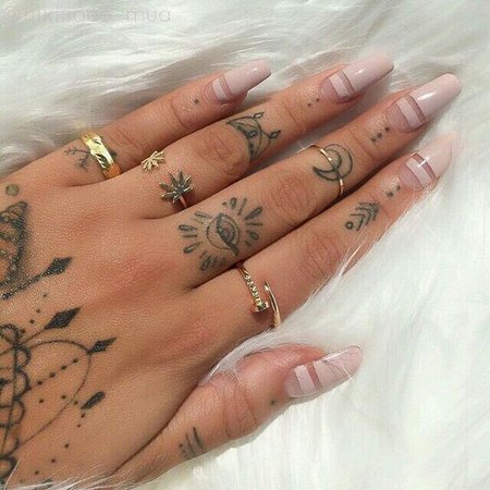 hand with tattoos and rings