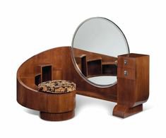 A FRENCH ART DECO BRAZILIAN ROSEWOOD CURVED DRESSING TABLE WITH SEAT AND CIRCULAR MIRROR (1930s)