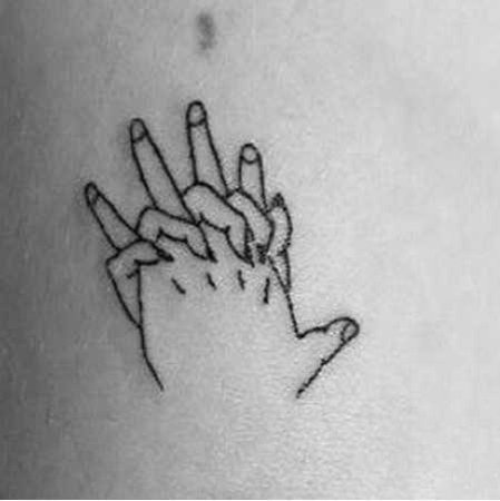 grasping hands tattoo