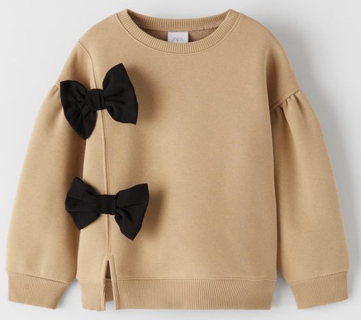 tan with black bow sweater