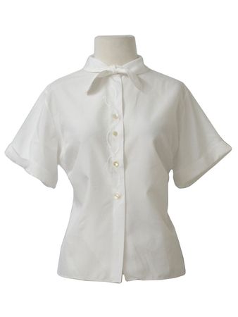 The Pilot Blouse 1950s Vintage Shirt: 50s style (made in 70s) -The Pilot Blouse- Womens white silky polyester short sleeve shirt. A tapered fit, bust darts, cuffed sleeves, fold down collar with embroidered front tie detail and embroidered button placket.