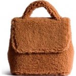 Gigi Hadid wears Mlouye Micro Convertible Shearling Teddy Bear Bag, Miu Miu Knitted Jumper and Freda Salvador