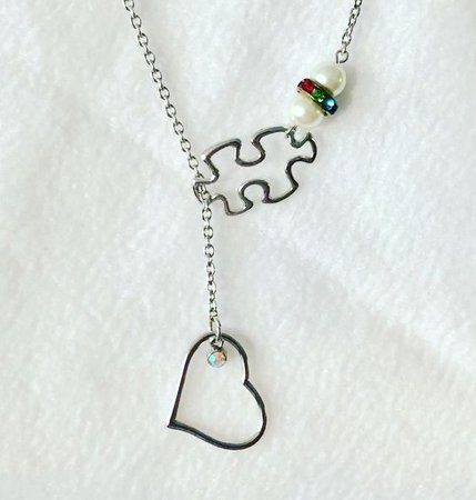 black puzzle and heart necklace