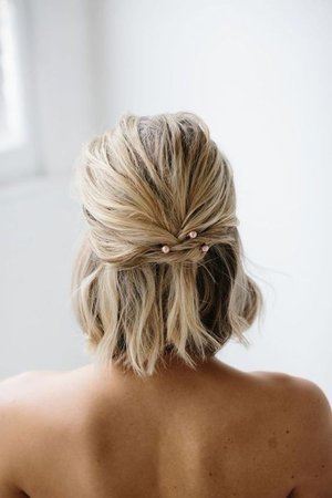 short blonde half up braid with pink pearl pins