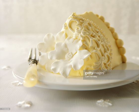 A Slice Of Wedding Cake With Flowers And Pearls Stock Photo | Getty Images