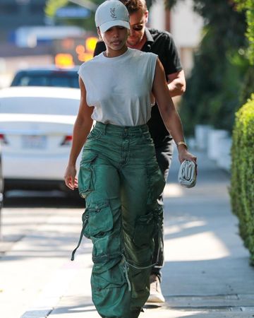 Get the Look: Lori Harvey Stepped Out in Los Angeles in a $275 YSL Cap with $1,000 The Attico Cargo Pants and a $2,350 Bottega Veneta Pouch – Fashion Bomb Daily