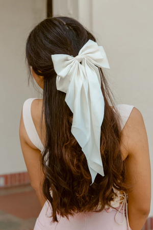 long wavy brunette hair with white coquette bow