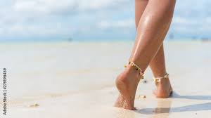 woman feet in the sand