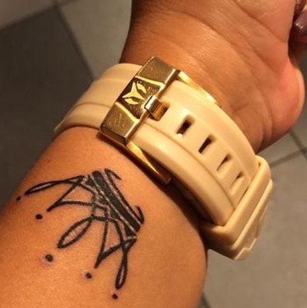 crown wrist tattoo