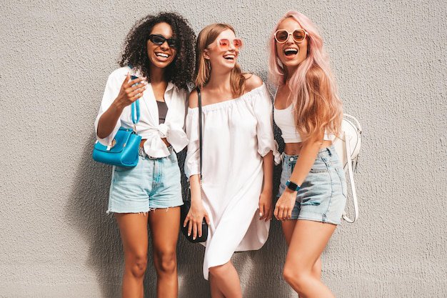 Free Photo | Three young beautiful smiling female in trendy summer clothessexy carefree multiracial women posing on the street backgroundpositive models having fun in sunglasses cheerful and happy