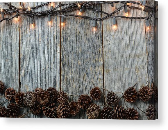 Christmas Lights and Pinecones on Rustic Wood Background Acrylic Print by Brandon Bourdages